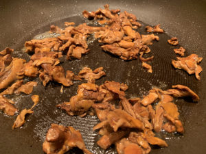Chanterelles cooking in a non stick skillet.