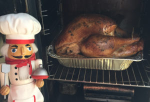 Pepe checking the turkey while it smokes
