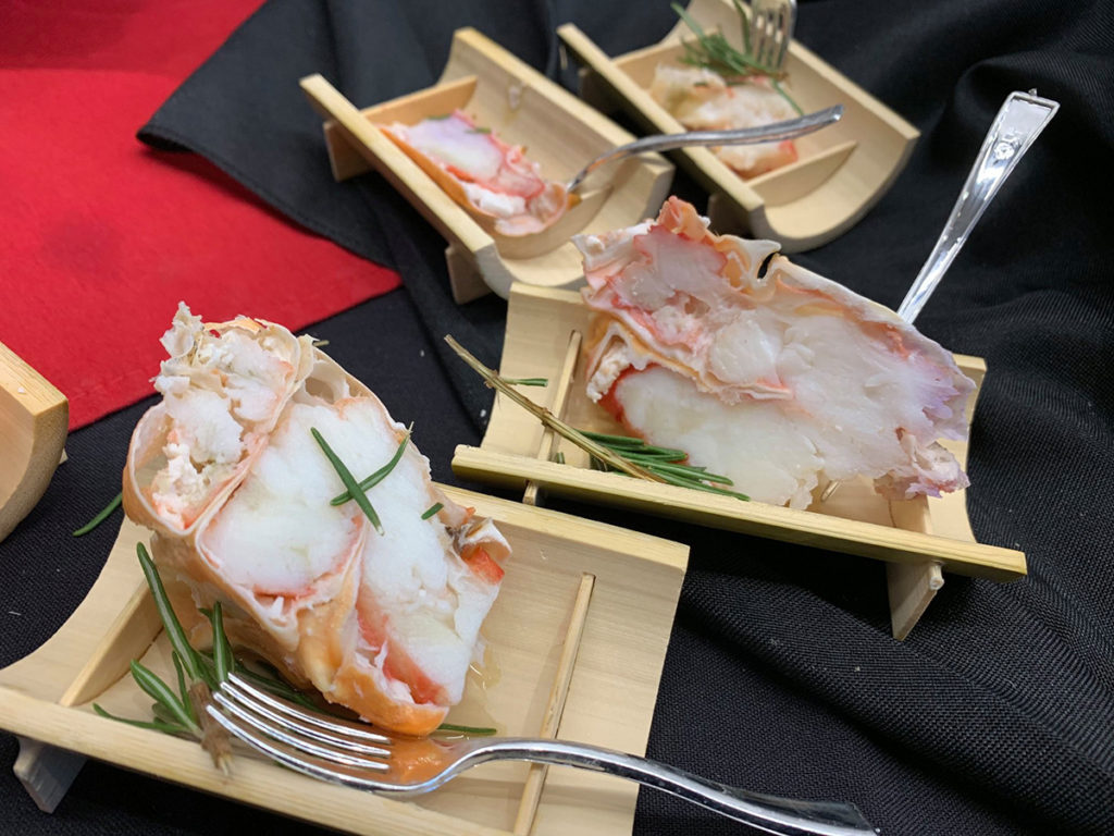 King Crab Appetizer in bamboo boats on black napkins