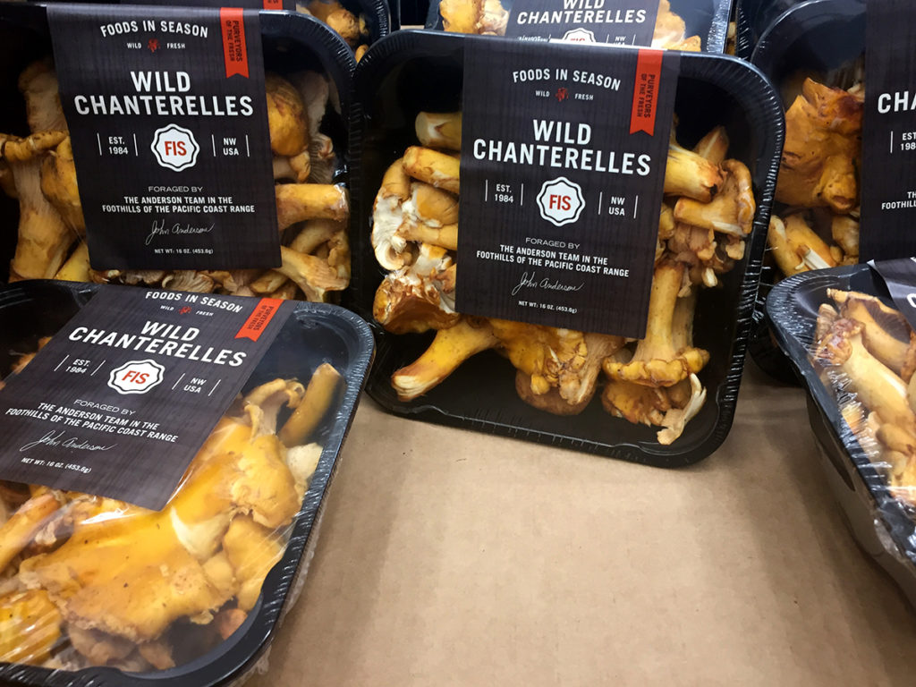 Packaged chanterelle mushrooms on a shelf in Costco.