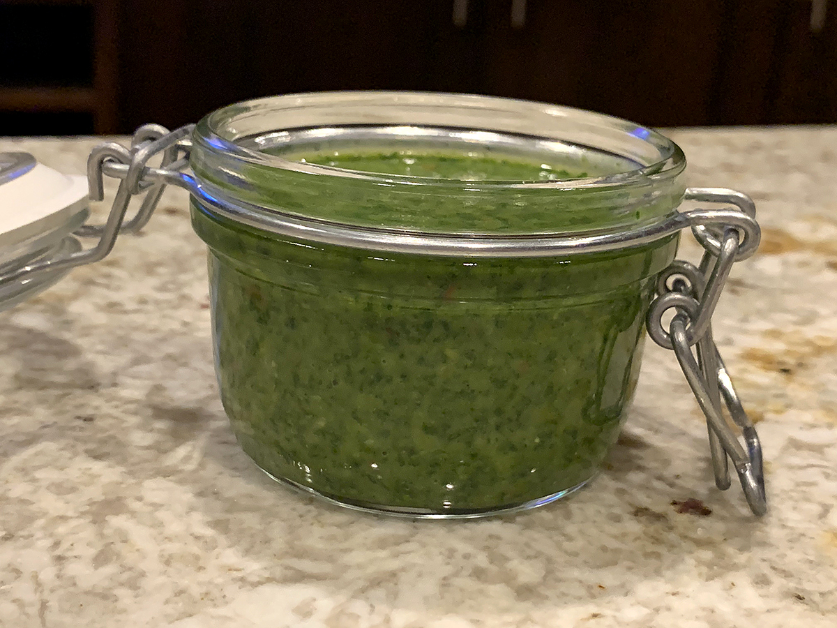 Green sauce in glass jar. 