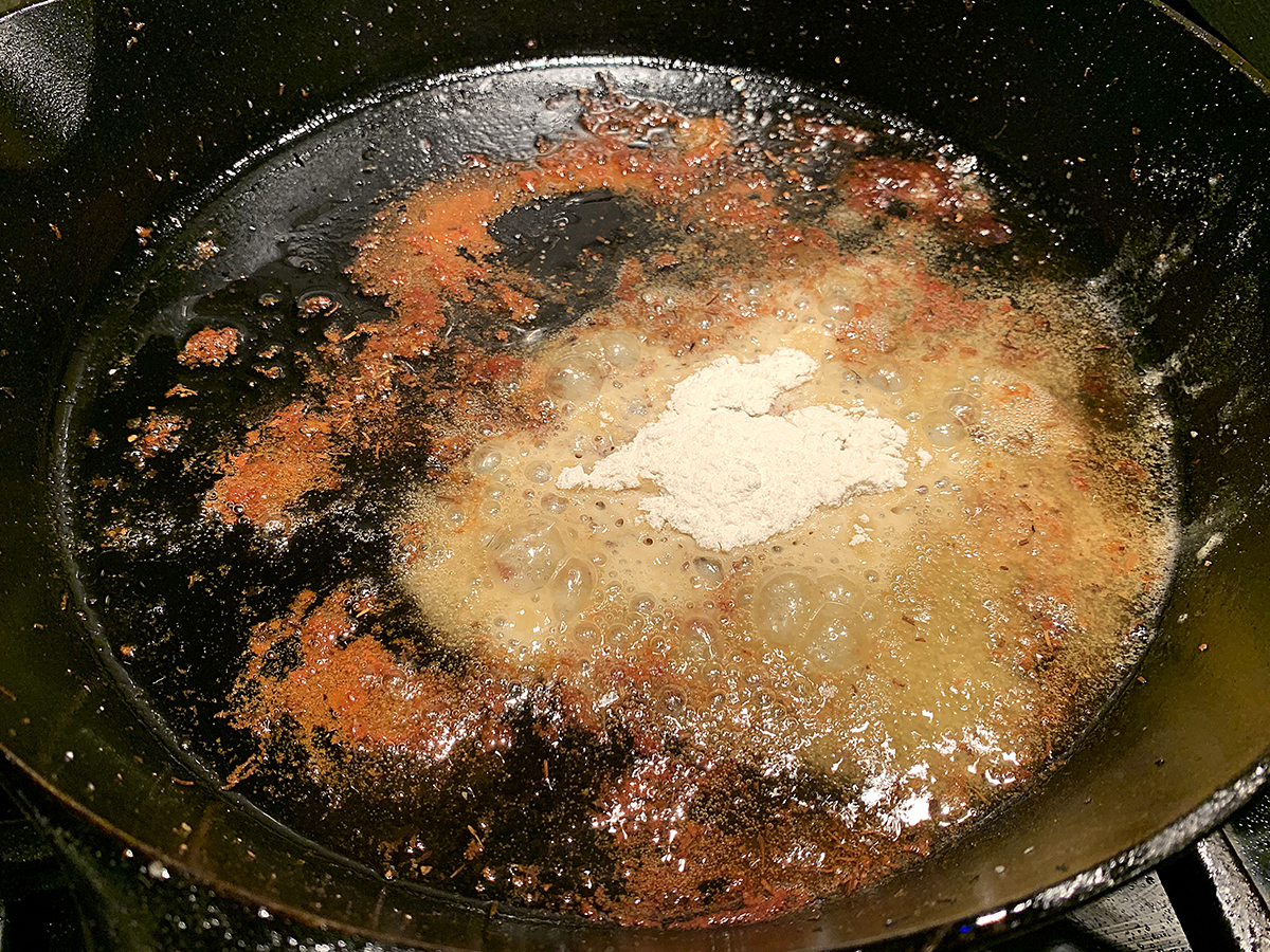 Pan dripping and flour in an iron skillet.