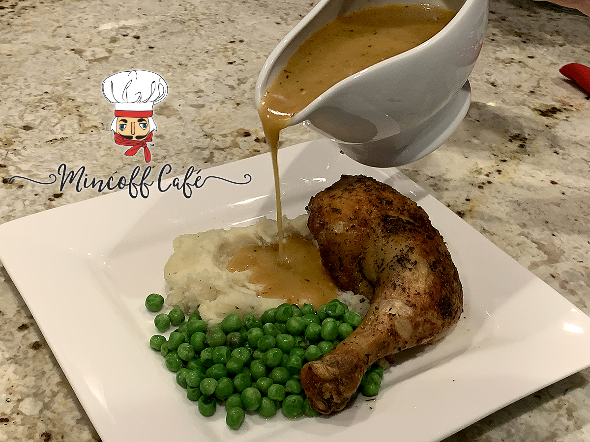 Square white plate with Chicken leg quarter, peas and mashed potatoes. Gravy is being poured out of a white dish onto the mashed potatoes.