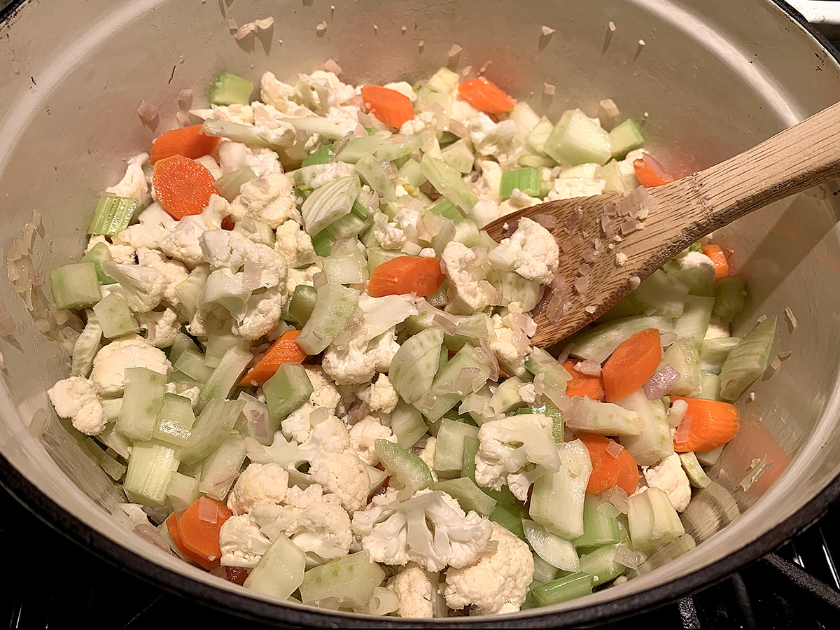 Chopped carrots, celery, cauliflower and fennel in a dutch oven.