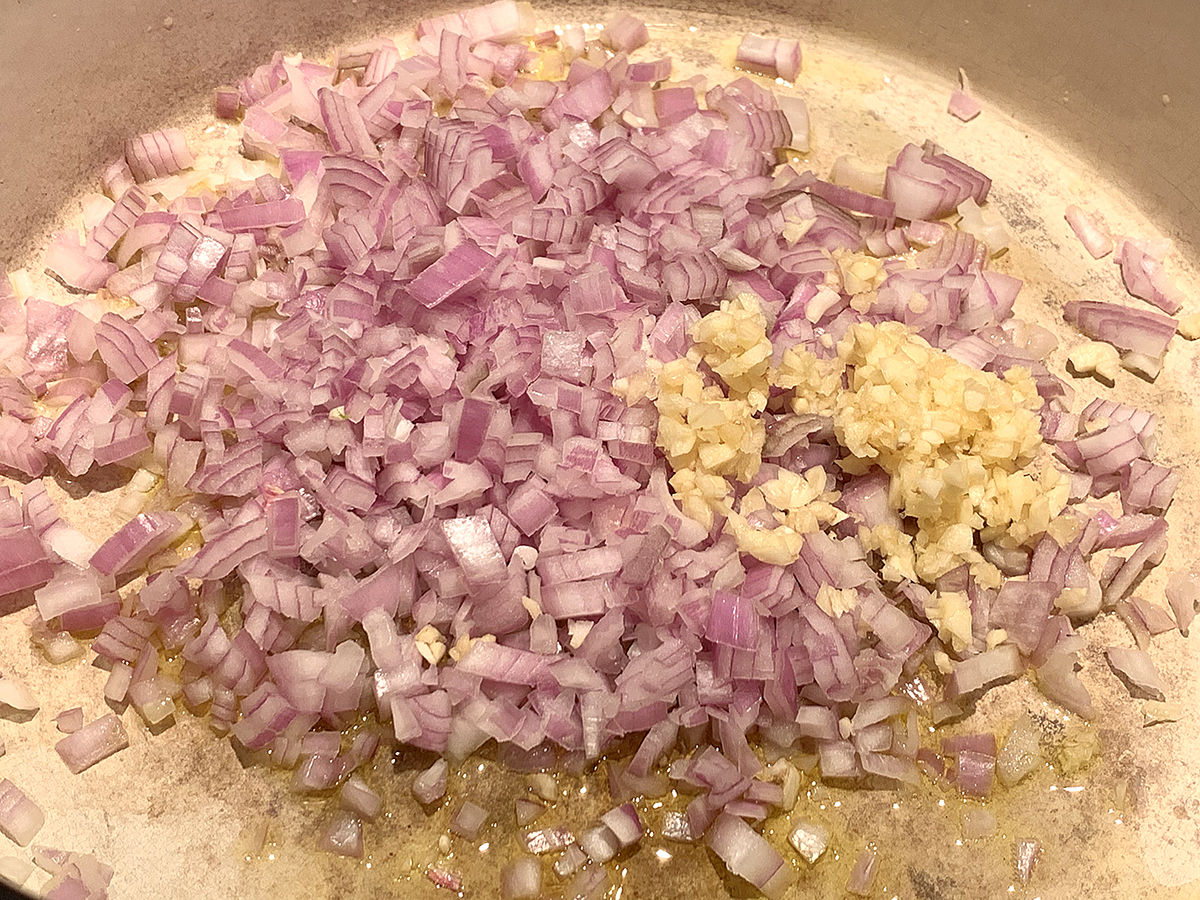 Minced Shallots and minced garlic sautéing in a dutch oven .