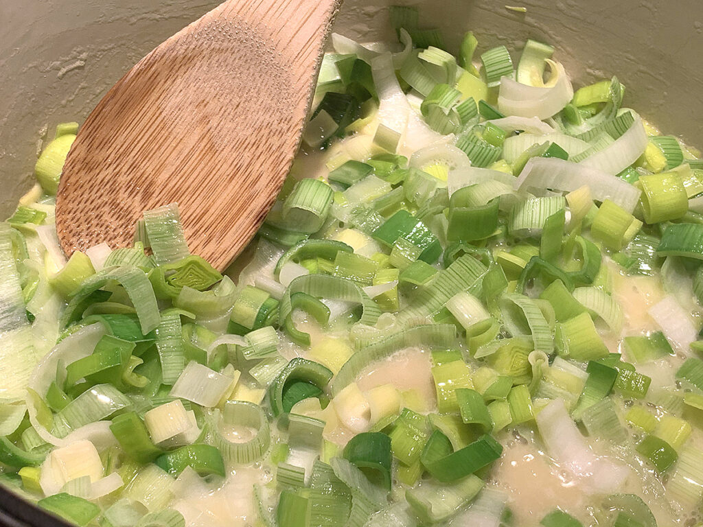 Chopped leeks and sautéing in melted butter. 