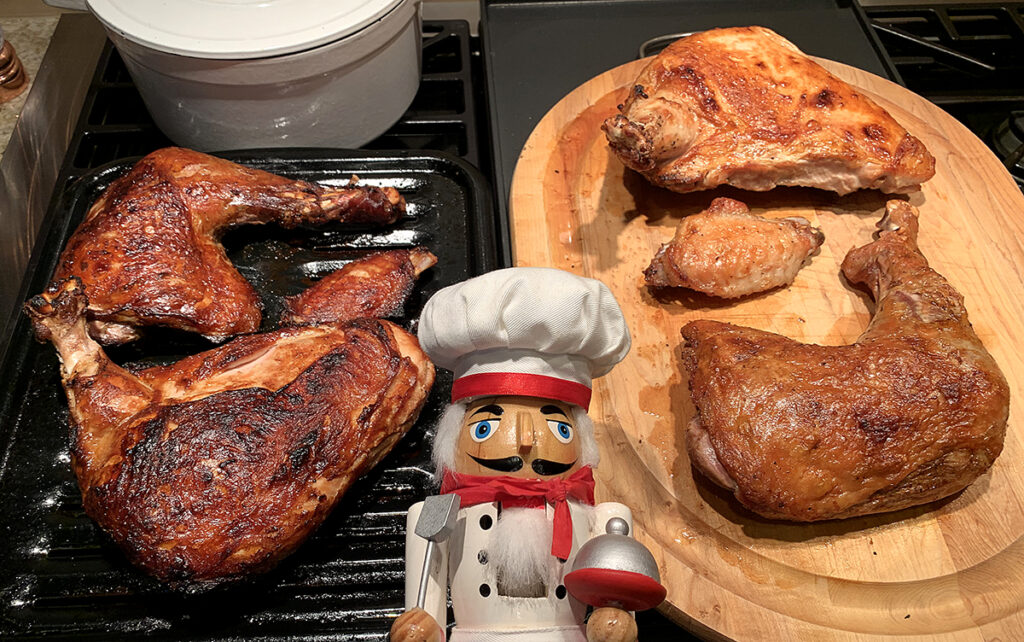 Nicely browned turkey quarters with a nutcracker who looks like a chef.