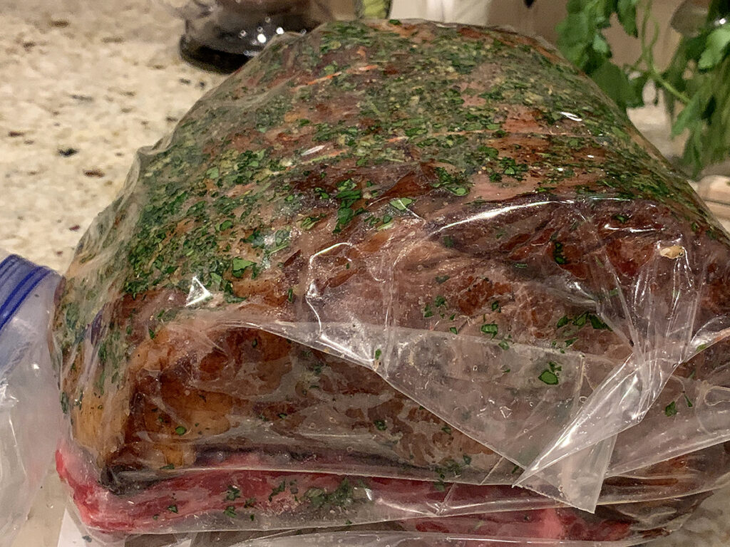 Seasoned and seared rib roast double bagged for sous vide.