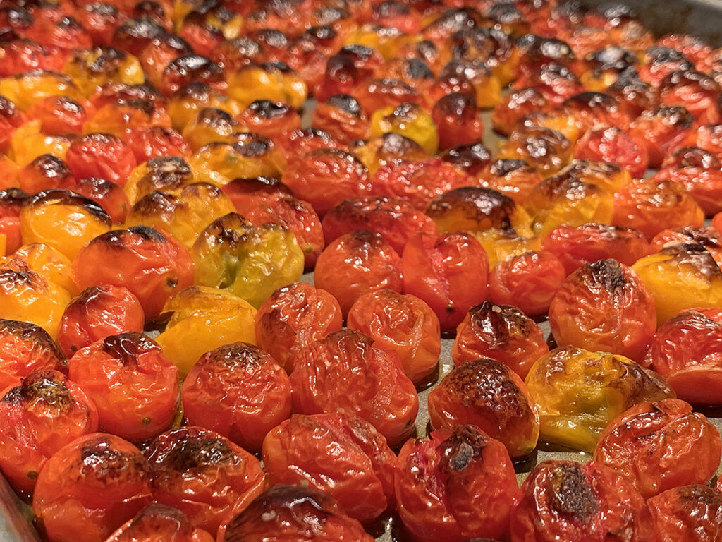 Red and yellow tiny tomatoes roasted until they get some char color on them. 