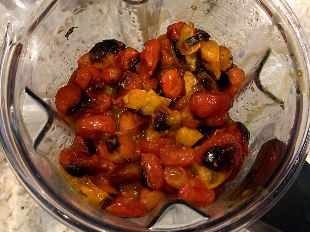 Roasted tomatoes and vegetables in a blender.