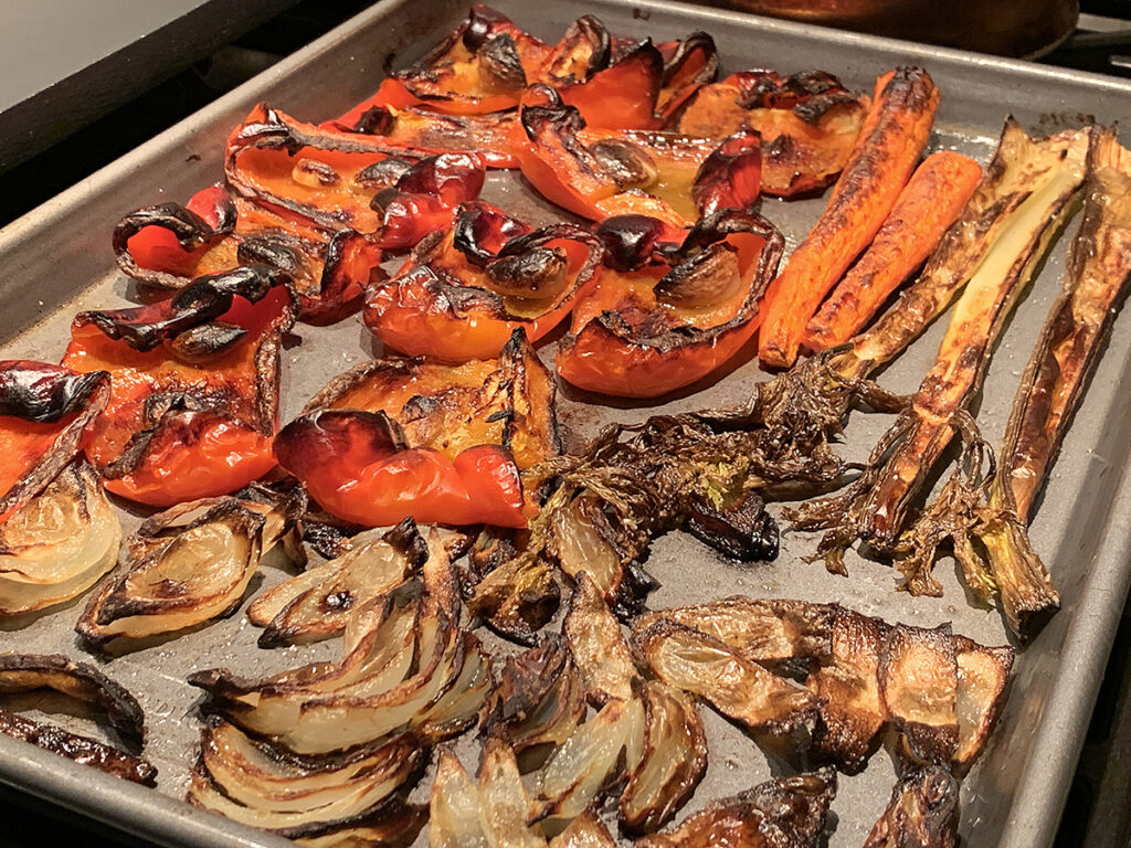 Red bell pepper, carrots, celery, onions, and garlic roasted until they get some char color on them.