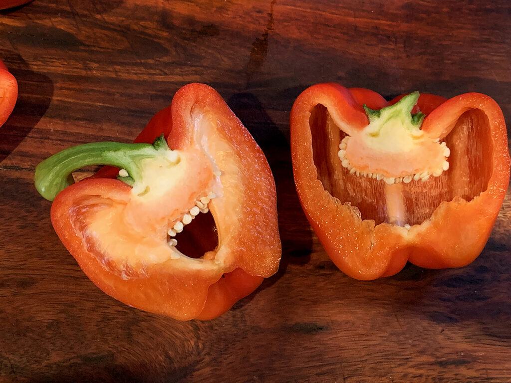 One red bell pepper cut vertically to show the inside which looks like a funny face.
