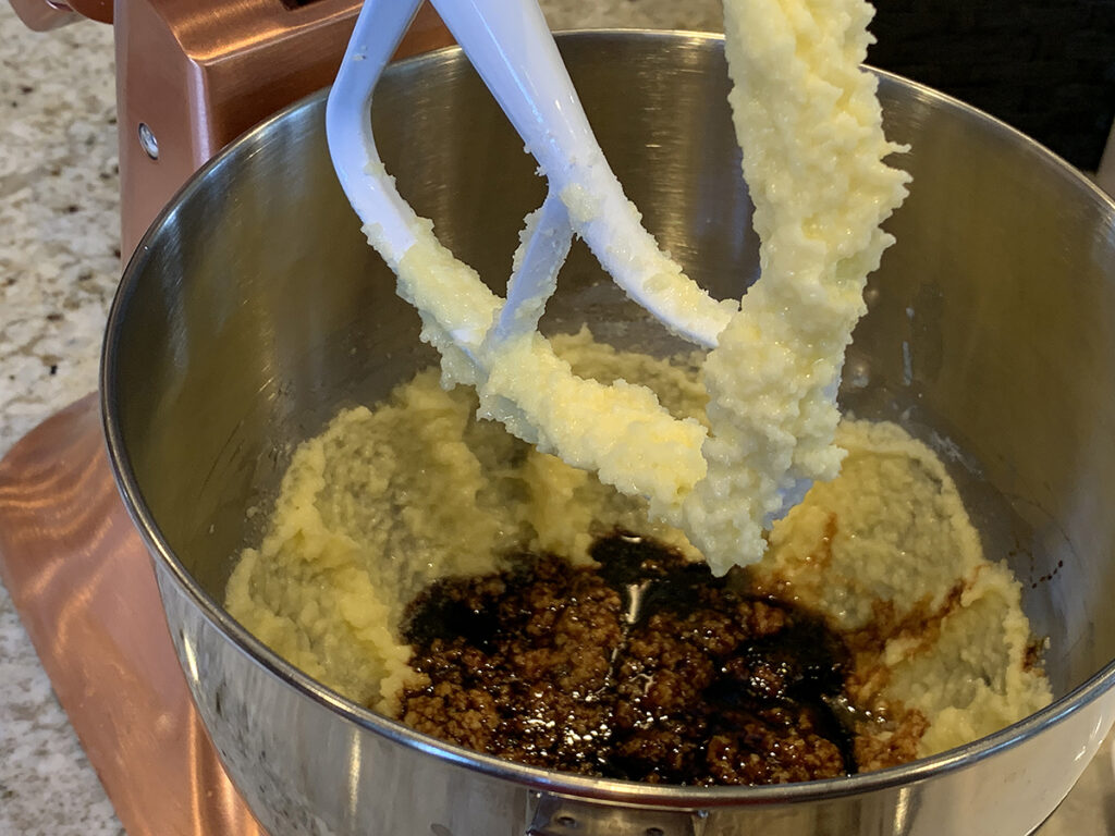 Mixing gingerbread dough in a stand mixer with the paddle attachment. 